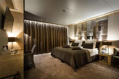 a bedroom with a large bed and a large window at Thermen Londerzeel Hotel in Londerzeel