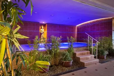 a purple room with plants and a swimming pool at Thermen Londerzeel Hotel in Londerzeel
