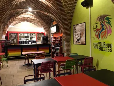 a restaurant with tables and chairs in a room at Antwerp City Hostel in Antwerp