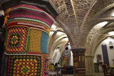 a colorful rug on a column in a building at Antwerp City Hostel in Antwerp