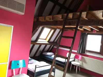 a room with two bunk beds and two windows at Antwerp City Hostel in Antwerp