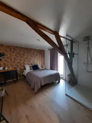 a bedroom with a bed and a desk and a window at De Blauwe Hoeve in Zwijndrecht
