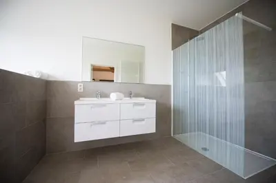 a bathroom with a sink and a shower at De Blauwe Hoeve in Zwijndrecht