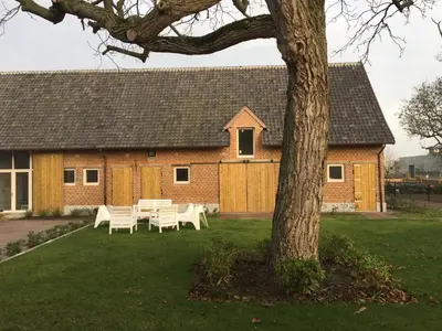 a group of tables and chairs in front of a building at De Blauwe Hoeve in Zwijndrecht