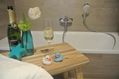 a table with a wine glass and a bottle of champagne at Lo-Gies in Lochristi