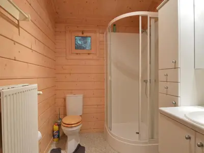 a bathroom with a toilet and a shower at Peaceful Chalet Retreat in Nijlen