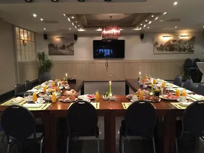 a long table with food and candles on it at Hotel The New Fox in Affligem