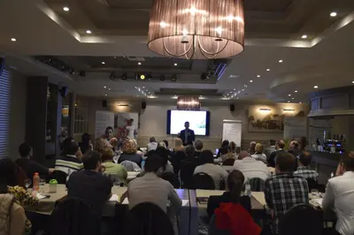 a group of people sitting in a room with a presentation at Hotel The New Fox in Affligem