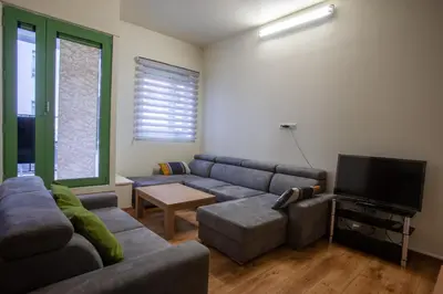 a living room with a couch and a flat screen tv at ATW Apartments in Antwerp
