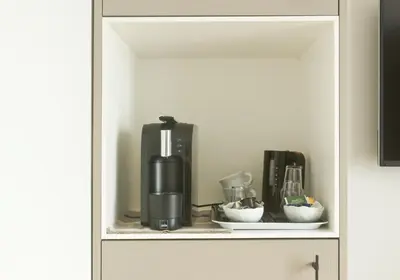 a cabinet with a coffee maker on a shelf at B&B Interludium in Nijlen