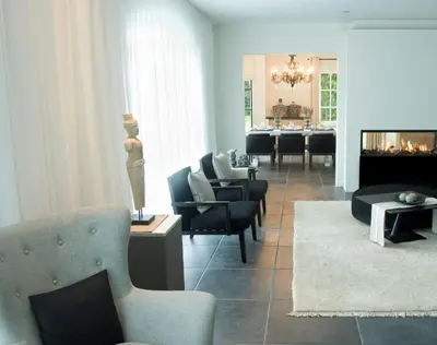 a living room with couches and a fire place at B&B Interludium in Nijlen