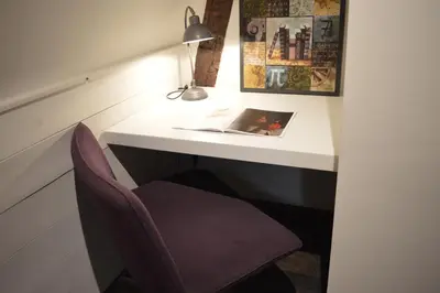 a desk with a chair and a lamp and a book at De Waterzooi Lodge in Ghent