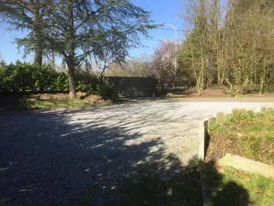 an empty road with a tree and a fence at Iosono by Moniek in Geel