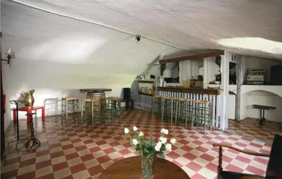 a room with chairs and a vase of flowers on a table at Kasteel Ter Leyen in Boekhoute