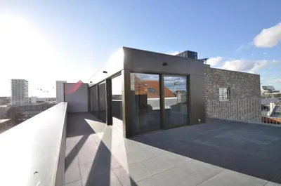 a building with large glass doors on a roof at Cadix 35 in Antwerp