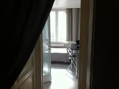 a room with a bedroom with a bed and a window at Résidence18 in Brussels