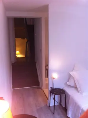 a bedroom with a bed and a staircase with a table at Résidence18 in Brussels