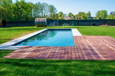 a swimming pool in the middle of a grass field at Aquarand in Hofstade