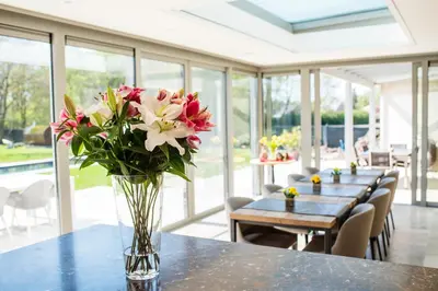 a vase filled with flowers sitting on a table at Aquarand in Hofstade