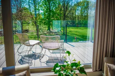 a screened in porch with chairs and a table at Aquarand in Hofstade