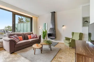 a living room with a couch and a table at Fuths Loft Penthouse 85 in Antwerp