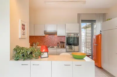 a kitchen with white cabinets and a red refrigerator at Fuths Loft Penthouse 85 in Antwerp