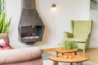 a living room with a fireplace in the wall at Fuths Loft Penthouse 85 in Antwerp