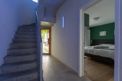 a staircase leading to a bedroom with a bed at Fred&Breakfast in Ghent
