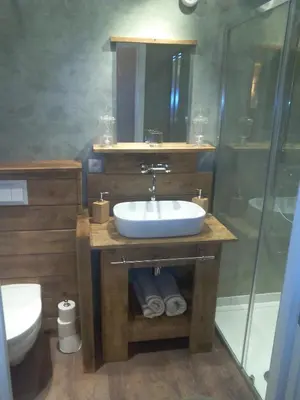 a bathroom with a sink and a shower at Bed and Breakfast Ros & Marc in Wezembeek-Oppem
