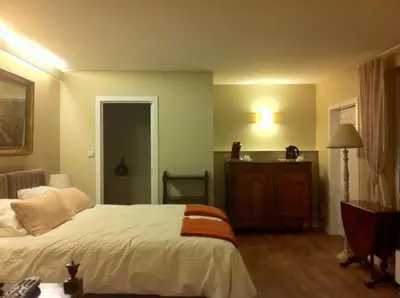 a bedroom with a bed and a dresser in it at Bed and Breakfast Ros & Marc in Wezembeek-Oppem