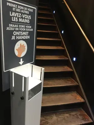 a set of stairs with a sign on the wall at All In One in Brussels