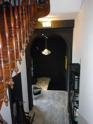 a hallway with a staircase and a chandelier at All In One in Brussels