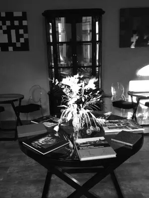 a table with books and flowers on top of it at All In One in Brussels