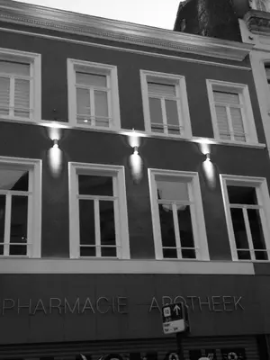a black and white photo of a building with lights at All In One in Brussels