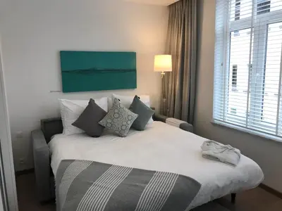 a bedroom with a large white bed with pillows at Antwerp Business Suites in Antwerp