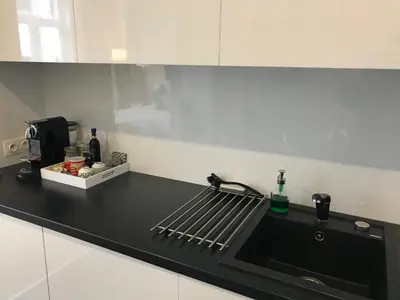 a kitchen with a black counter top with a sink at Antwerp Business Suites in Antwerp