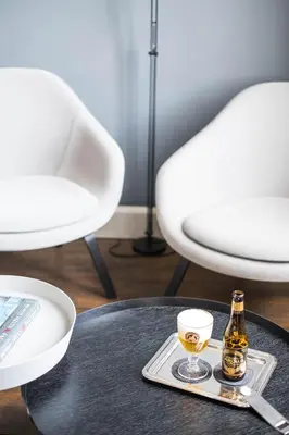 a bottle of beer and a glass on a table at B&B Dusk till dawn in Mechelen
