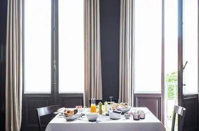 a table with a white table cloth and food on it at B&B Dusk till dawn in Mechelen