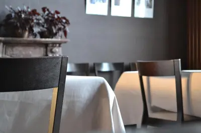 a table and chairs with a white table cloth on it at B&B Dusk till dawn in Mechelen