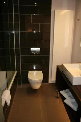 a bathroom with a toilet and a sink at Hotel Carpinus in Leuven