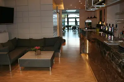 a restaurant with couches and a bar with a table at Hotel Carpinus in Leuven