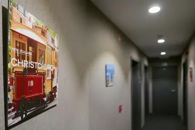 a poster of a train hanging on a wall in a hallway at Atlas Hotel Brussels in Brussels