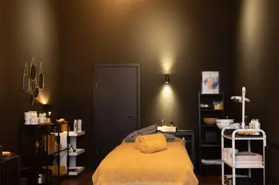 a room with a bed with a yellow blanket at Hotel 'T Sandt in Antwerp
