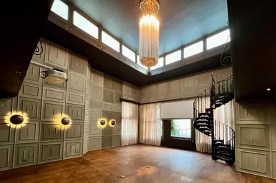 a large room with a staircase and a chandelier at Hotel 'T Sandt in Antwerp