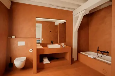 a bathroom with a toilet and a sink and a tub at Hotel 'T Sandt in Antwerp