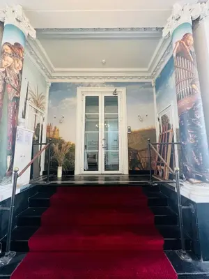 a red carpeted staircase in a room with a red carpet at Parkhotel Gent Centrum in Ghent