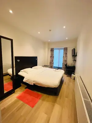 a bedroom with a large bed and a mirror at Parkhotel Gent Centrum in Ghent