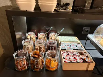 a table with jars and boxes of donuts at Parkhotel Gent Centrum in Ghent