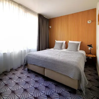 a hotel room with a bed and a window at Vintage Hotel Brussels in Brussels