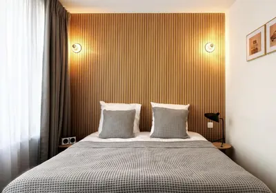 a bedroom with a bed with two pillows at Vintage Hotel Brussels in Brussels